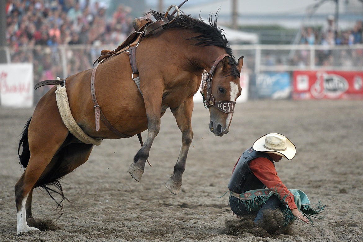 Tanner Hollenback, of Dillon, gets bucked off his horse Trail Smoke during the saddle bronc riding event at the Northwest Montana Fair PRCA Rodeo on Saturday evening at the Flathead County Fairgrounds. (Casey Kreider/Daily Inter Lake)