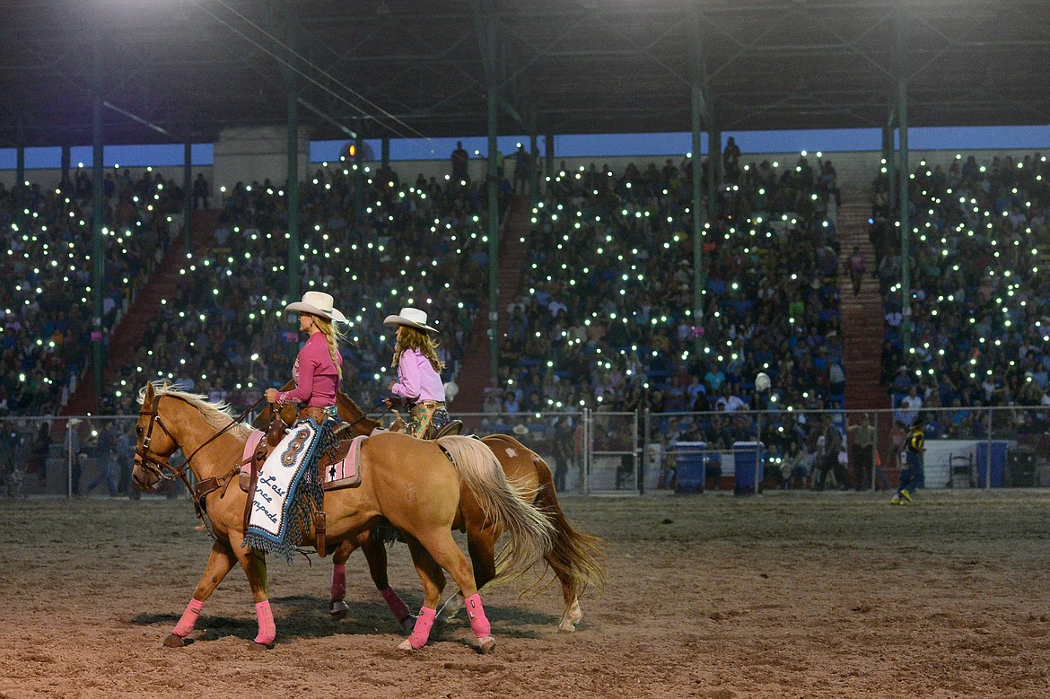 Rodeo fans hold their cell phones aloft during an intermission at the Northwest Montana Fair PRCA Rodeo on Saturday evening at the Flathead County Fairgrounds. (Casey Kreider/Daily Inter Lake)