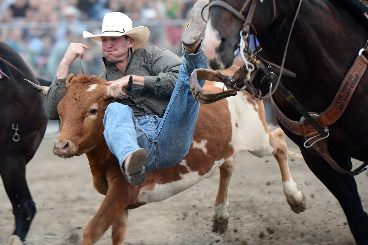 Luke Gee, of Stanford, MT, competes during the steer wrestling event at the Northwest Montana Fair PRCA Rodeo on Friday evening at the Flathead County Fairgrounds. (Casey Kreider/Daily Inter Lake)