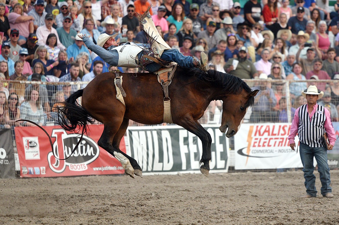 JR Vezain, of Cowley, Wyoming, holds on to his horse Make Believe during the bareback riding event at the Northwest Montana Fair PRCA Rodeo on Saturday evening at the Flathead County Fairgrounds. (Casey Kreider/Daily Inter Lake)