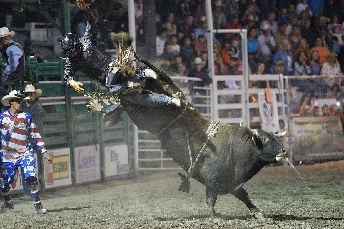 Jake Davis, of McCleary, WA, gets bucked off his bull Crocodile Rock during the bull riding event at the Northwest Montana Fair PRCA Rodeo on Friday evening at the Flathead County Fairgrounds. (Casey Kreider/Daily Inter Lake)