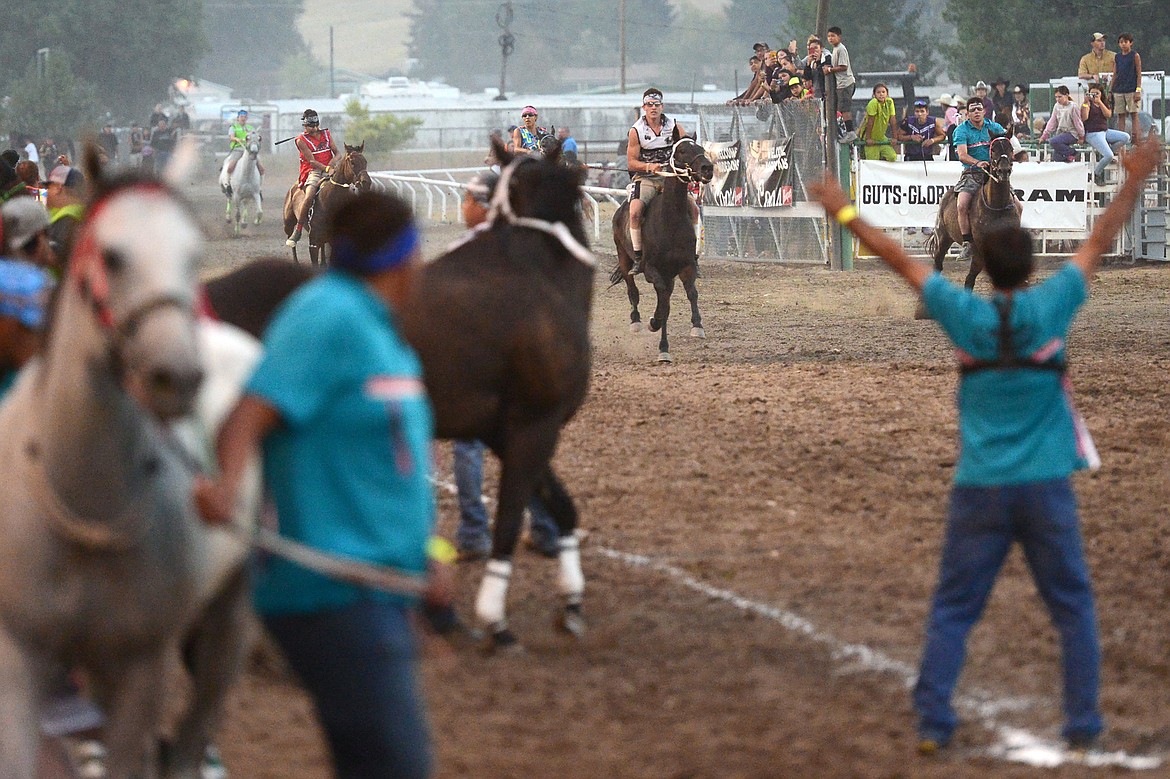 Riders complete a lap during the Indian Relay Races at the Northwest Montana Fair and Rodeo on Thursday. (Casey Kreider/Daily Inter Lake)