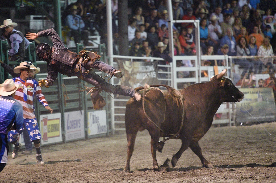 Jake Davis, of McCleary, WA, gets bucked off his bull Crocodile Rock during the bull riding event at the Northwest Montana Fair PRCA Rodeo on Friday evening at the Flathead County Fairgrounds. (Casey Kreider/Daily Inter Lake)