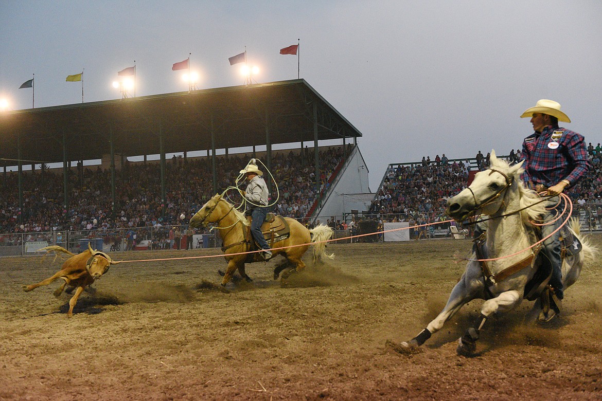 Kal Fuller, of Bozeman, and Ryan Zurcher, of Powell, Wyoming, compete during the team roping event at the Northwest Montana Fair PRCA Rodeo on Saturday evening at the Flathead County Fairgrounds. (Casey Kreider/Daily Inter Lake)