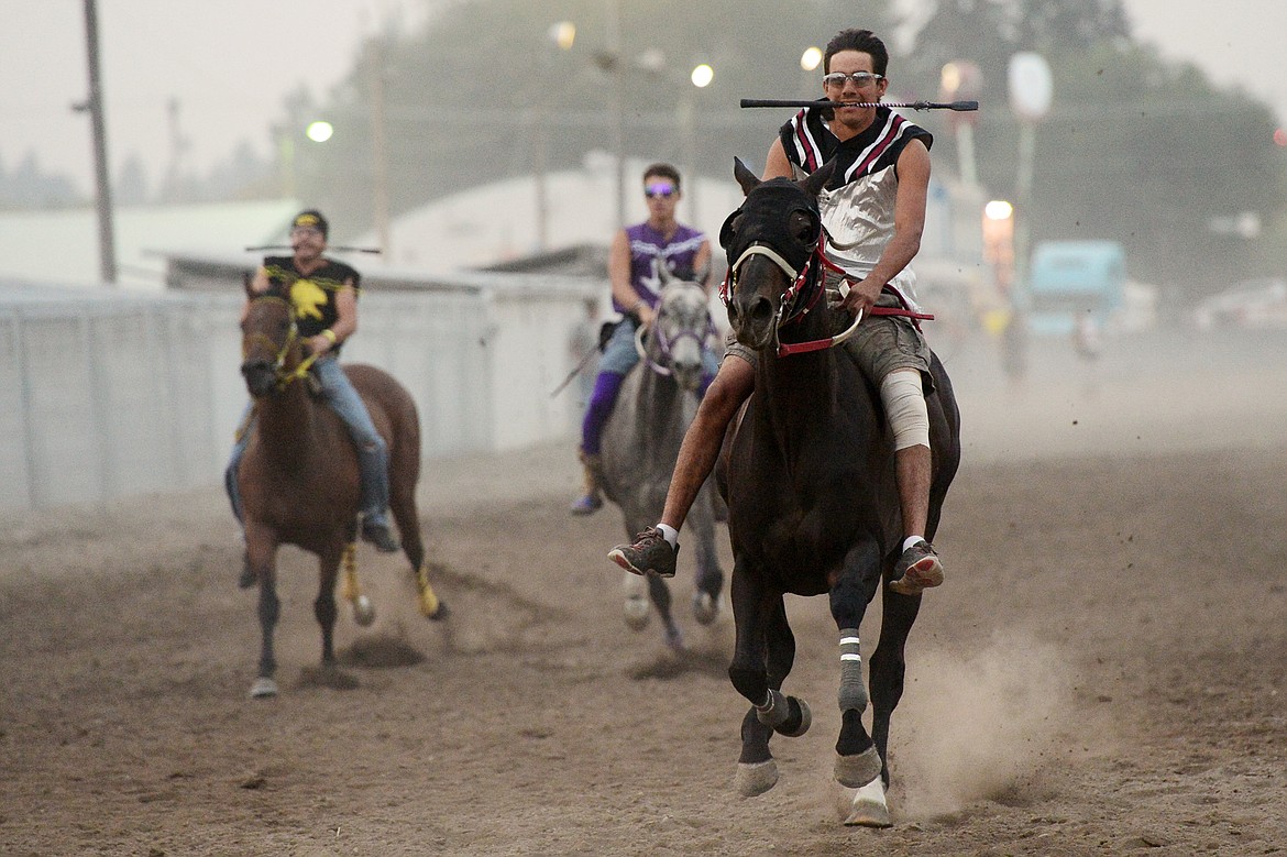 Riders race during the Indian Relay Races at the Northwest Montana Fair PRCA Rodeo on Saturday evening at the Flathead County Fairgrounds. (Casey Kreider/Daily Inter Lake)