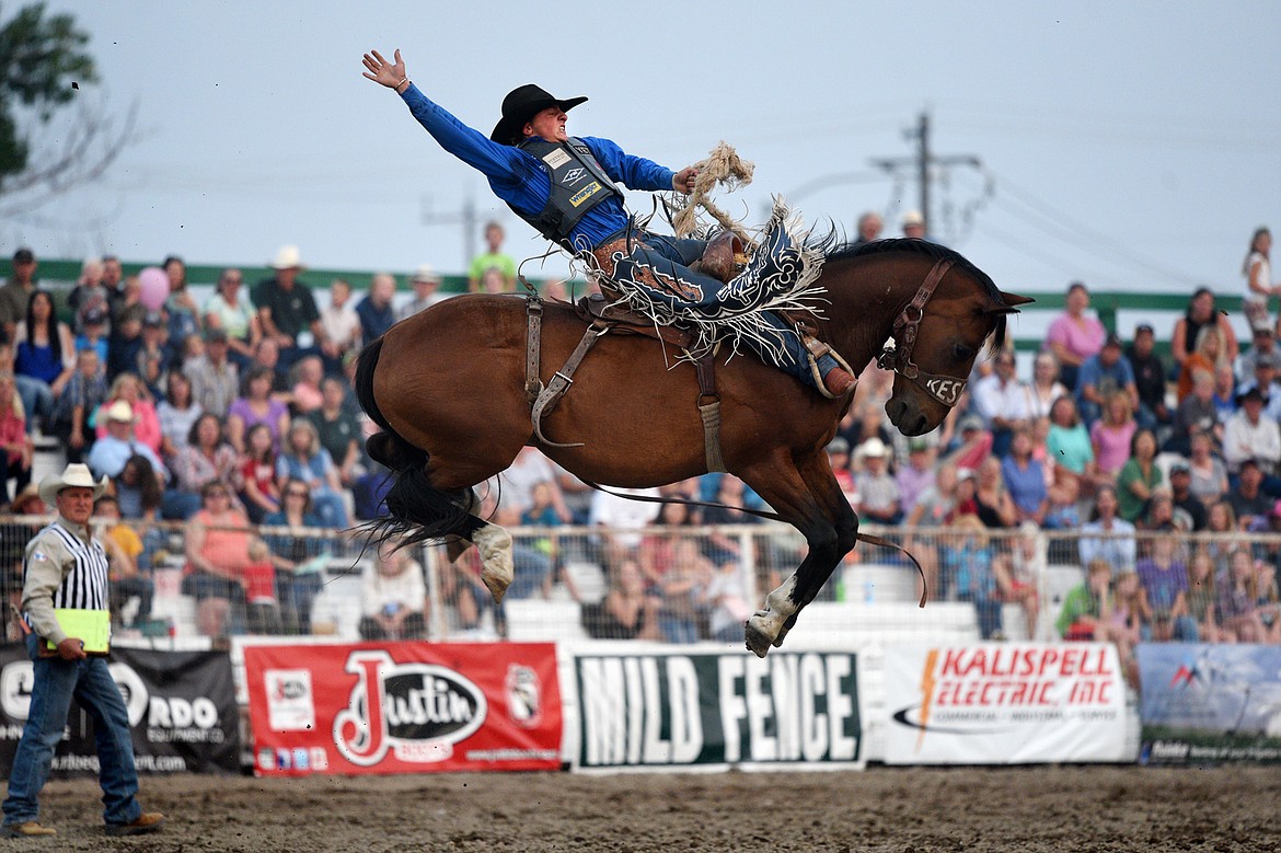 Rusty Wright, of Milford, UT, hangs on to his horse Believe Me during the Saddle Bronc Riding event at the Northwest Montana Fair and Rodeo on Thursday. (Casey Kreider/Daily Inter Lake)