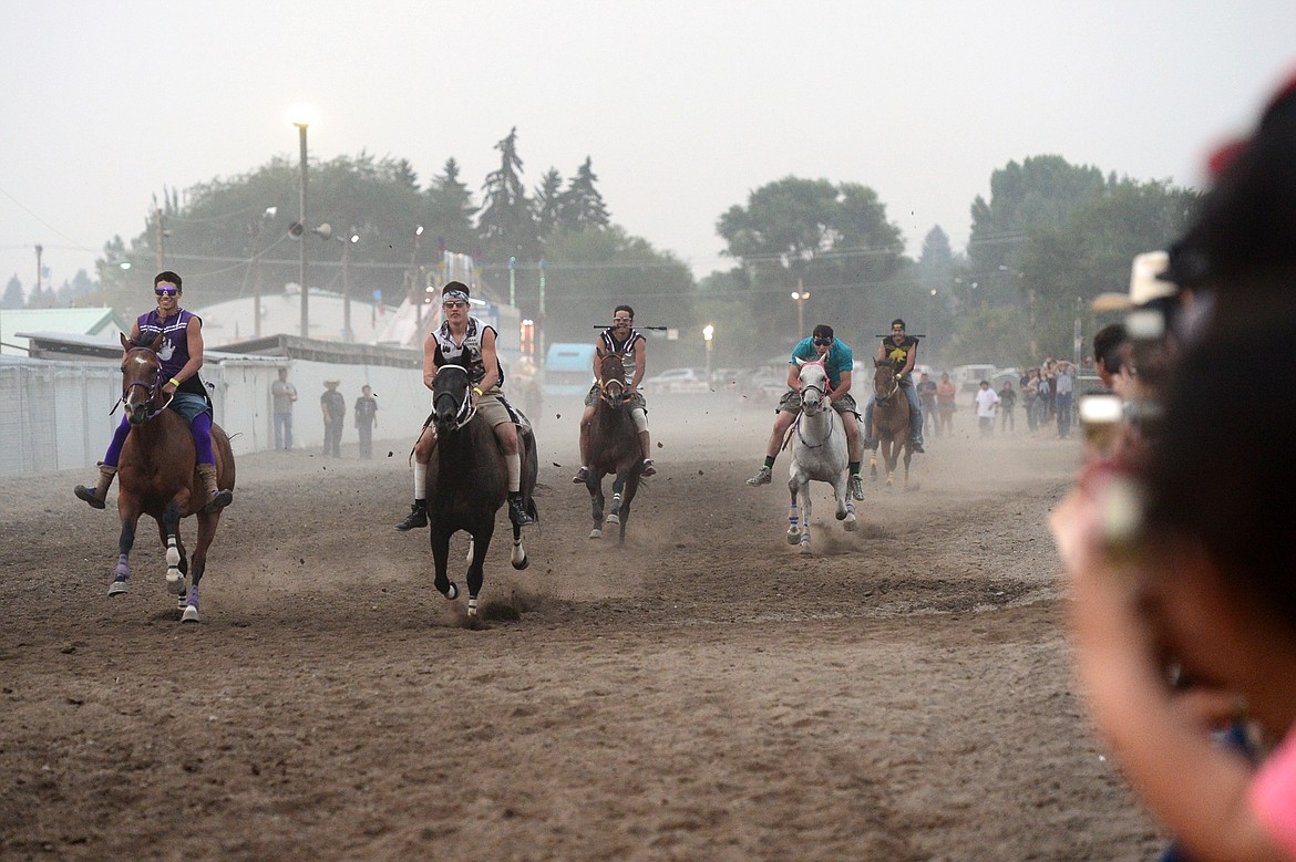 Riders race during the Indian Relay Races at the Northwest Montana Fair PRCA Rodeo on Saturday evening at the Flathead County Fairgrounds. (Casey Kreider/Daily Inter Lake)