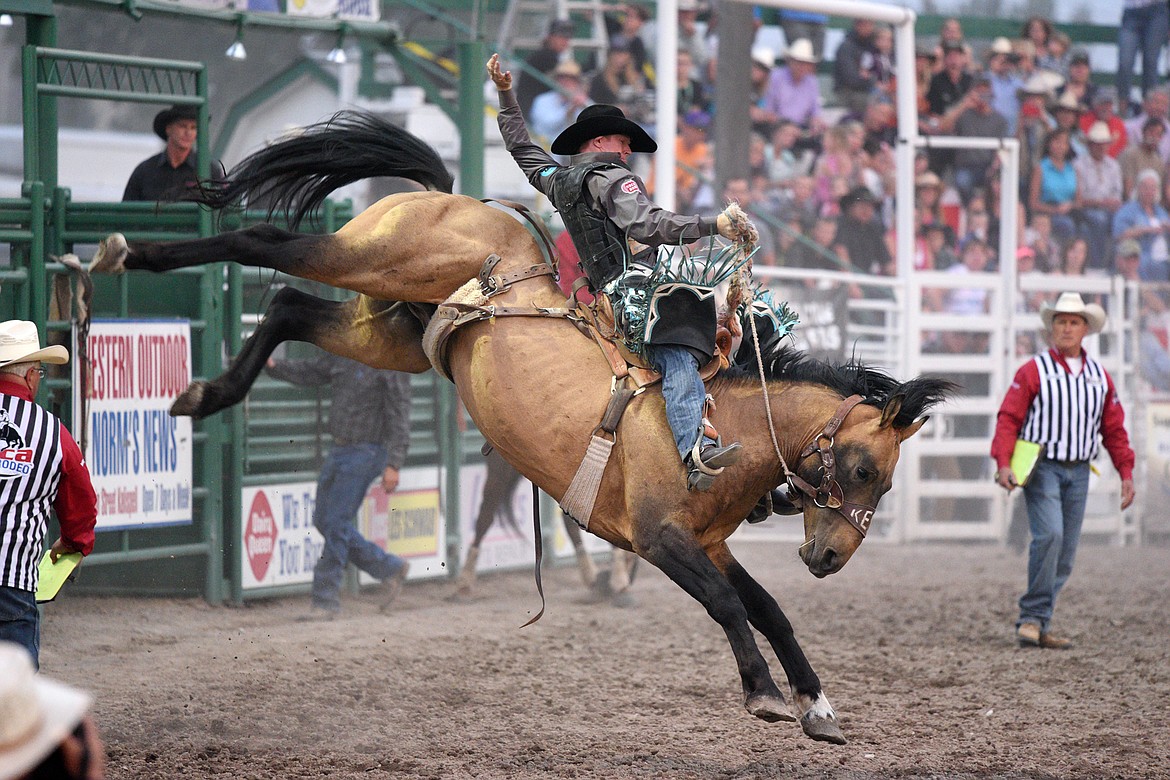 Jacobs Crawley, of Boerne, TX, holds on to his horse Copper Cat during the saddle bronc riding event at the Northwest Montana Fair PRCA Rodeo on Friday evening at the Flathead County Fairgrounds. (Casey Kreider/Daily Inter Lake)