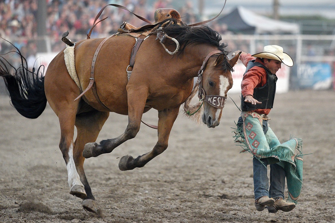 Tanner Hollenback, of Dillon, gets bucked off his horse Trail Smoke during the saddle bronc riding event at the Northwest Montana Fair PRCA Rodeo on Saturday evening at the Flathead County Fairgrounds. (Casey Kreider/Daily Inter Lake)