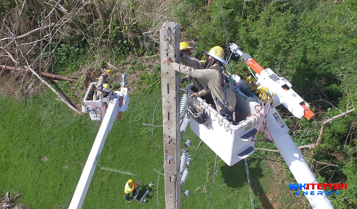 A crew from Kissimmee Utility Authority, one of several municipal utilities that came to assist with Hurricane Maria storm repairs under Whitefish Energy Holdings, repairs damaged power lines in Puerto Rico last fall. (Photo courtesy of Whitefish Energy)