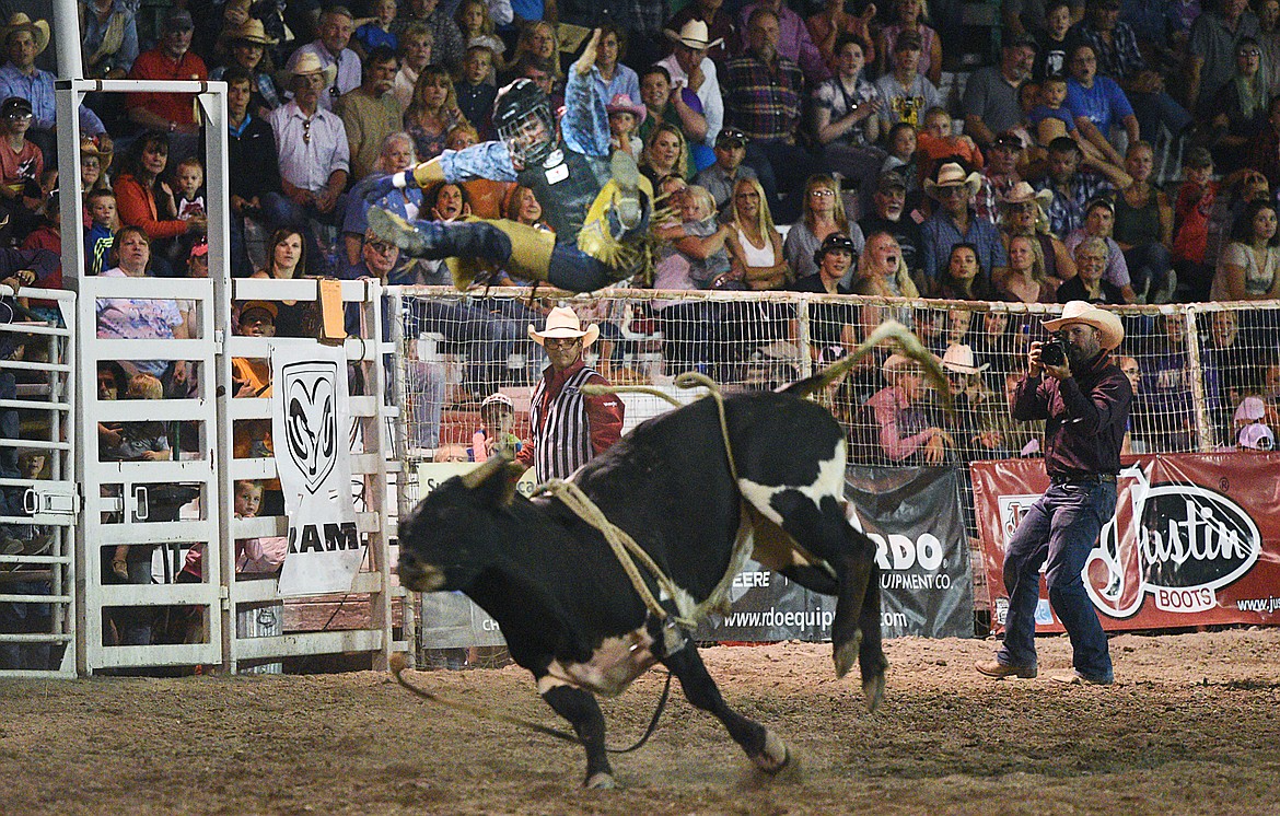 Corey Dryden of LaGrange, Texas, gets blown off by Short Fuse during the bull riding event at the Northwest Montana Fair PRCA Rodeo on Friday evening at the Flathead County Fairgrounds. (Casey Kreider/Daily Inter Lake)