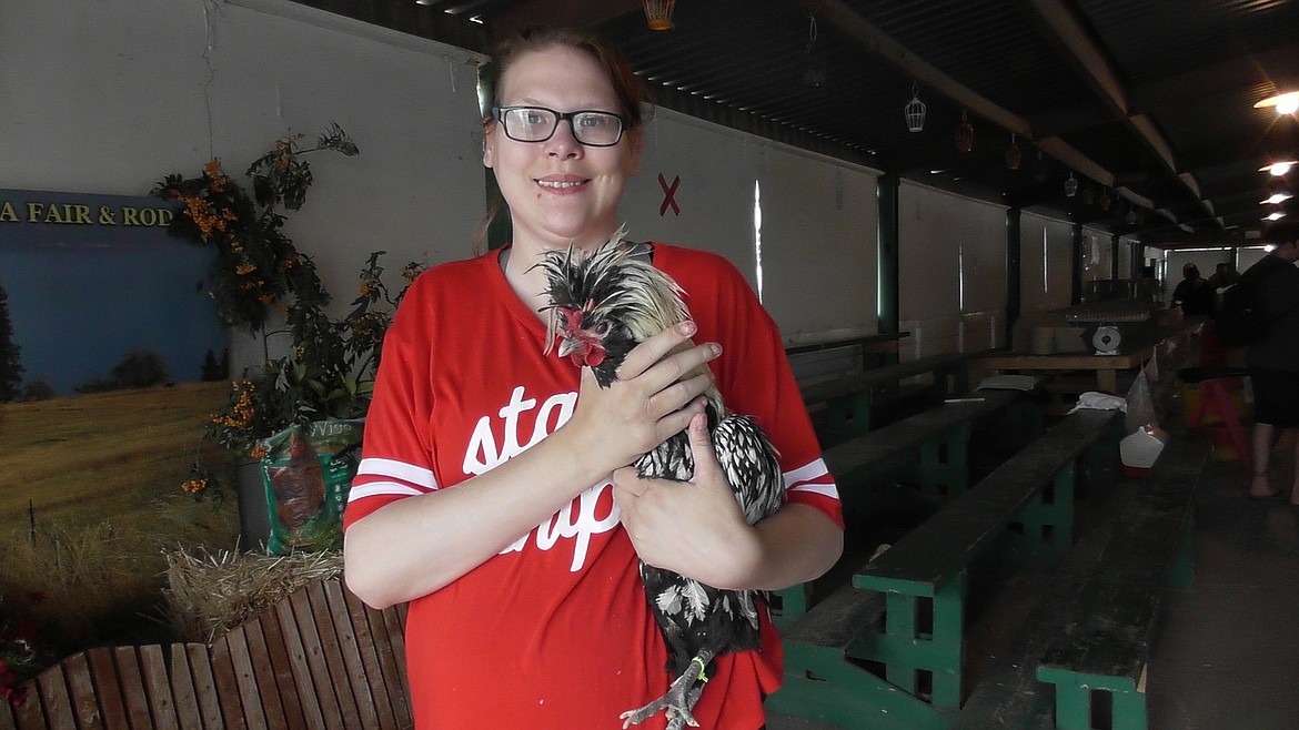 Kayla Ekern, of Kalispell, shows off her Polish Cross rooster, &#147;Hei Hei,&#148; after it won the rooster crowing contest Friday at the Northwest Montana Fair. (Scott Shindledecker/Daily Inter Lake)