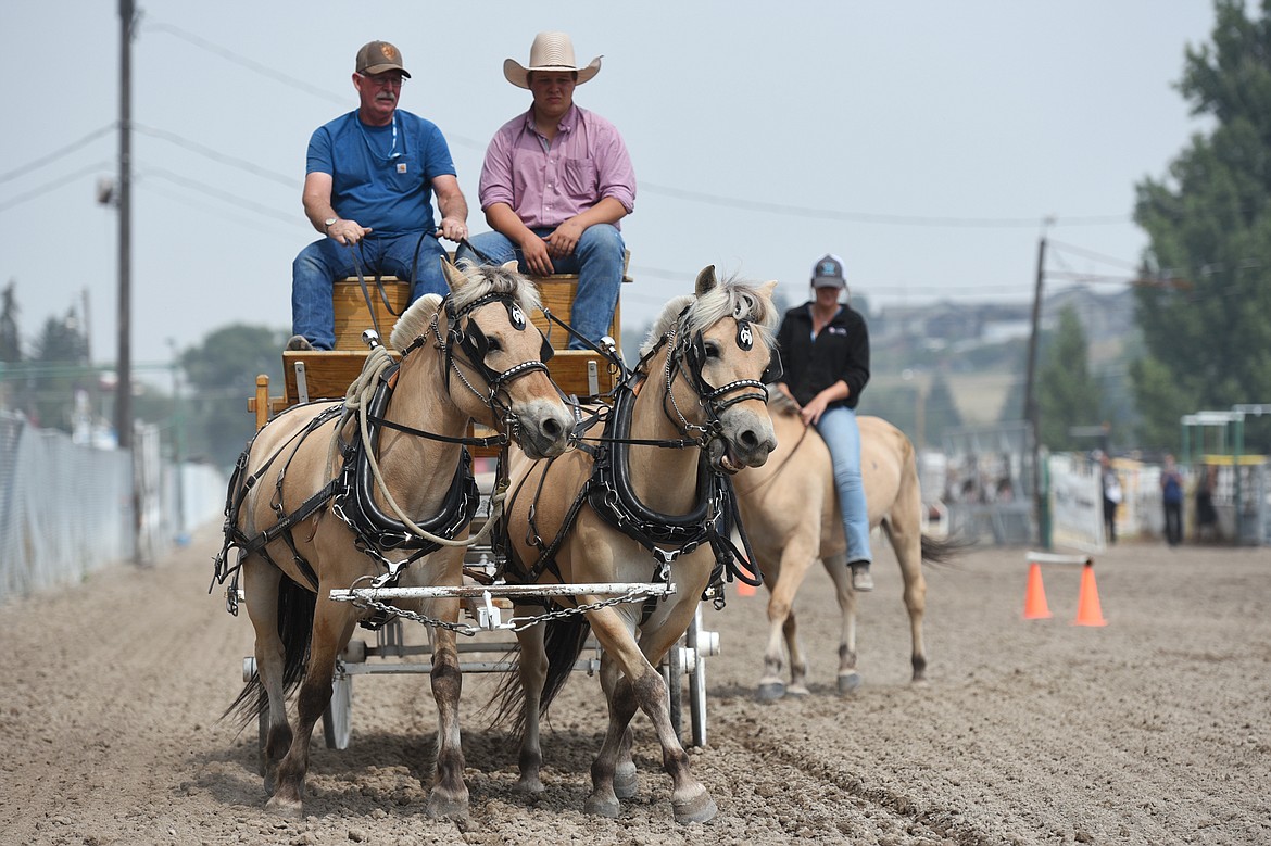 Hugh Naldrett and Dale Olson ride behind Fjords Eva and Tina during the draft horse show at the Northwest Montana Fair and Rodeo on Thursday. (Casey Kreider/Daily Inter Lake)