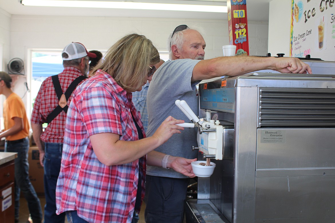 Cheryl Schweizer/Columbia Basin HeraldVolunteers serve ice cream on a busy afternoon at the Block 40 booth. Proceeds from the booth go to support programs for kids in Block 40.