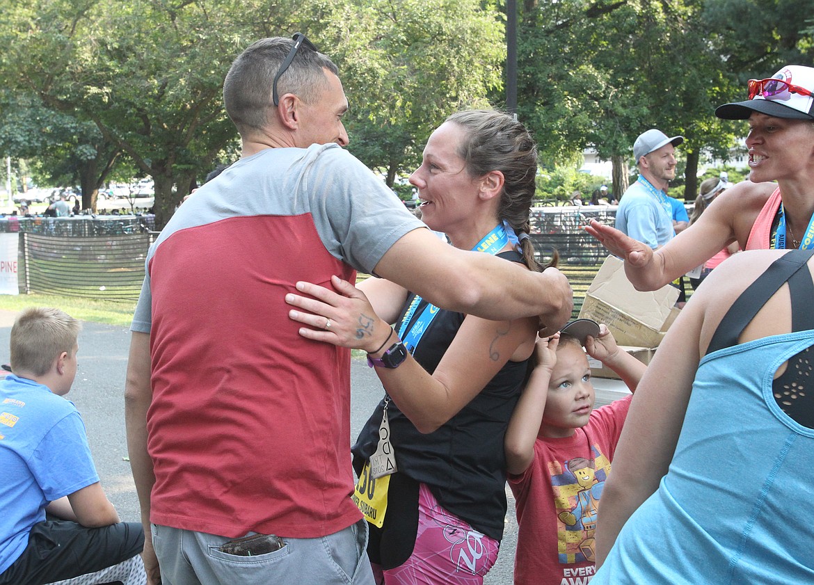 DEVIN WEEKS/Press
Coeur d&#146;Alene mom of three Michelle Vetsch receives a big hug from proud husband Nathan Vetsch after she completed the Olympic race of the 34th annual Coeur d&#146;Alene Triathlon on Saturday.