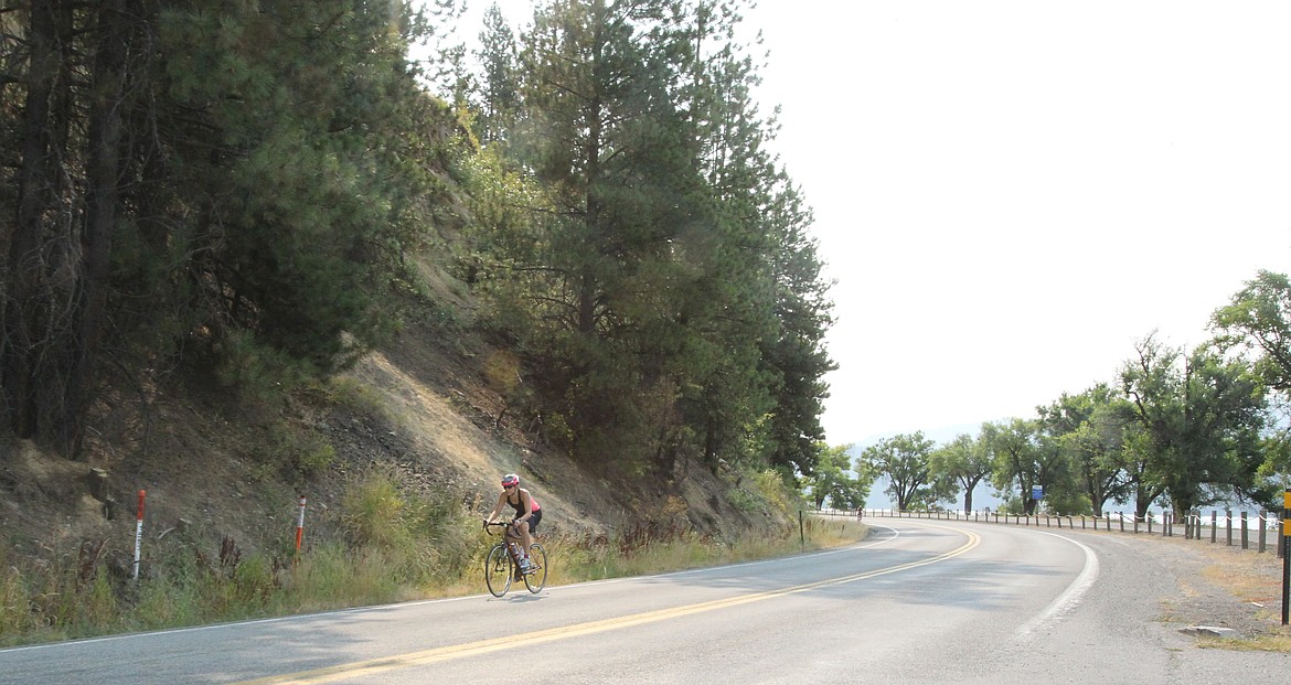 Cyclists zip down Coeur d'Alene Lake Drive during the 34th annual Coeur d'Alene Triathlon on Saturday morning. Nearly 450 athletes participated in one of the race day events, which included the triathlon, a duathlon and the Scenic Sprint. (DEVIN WEEKS/Press)