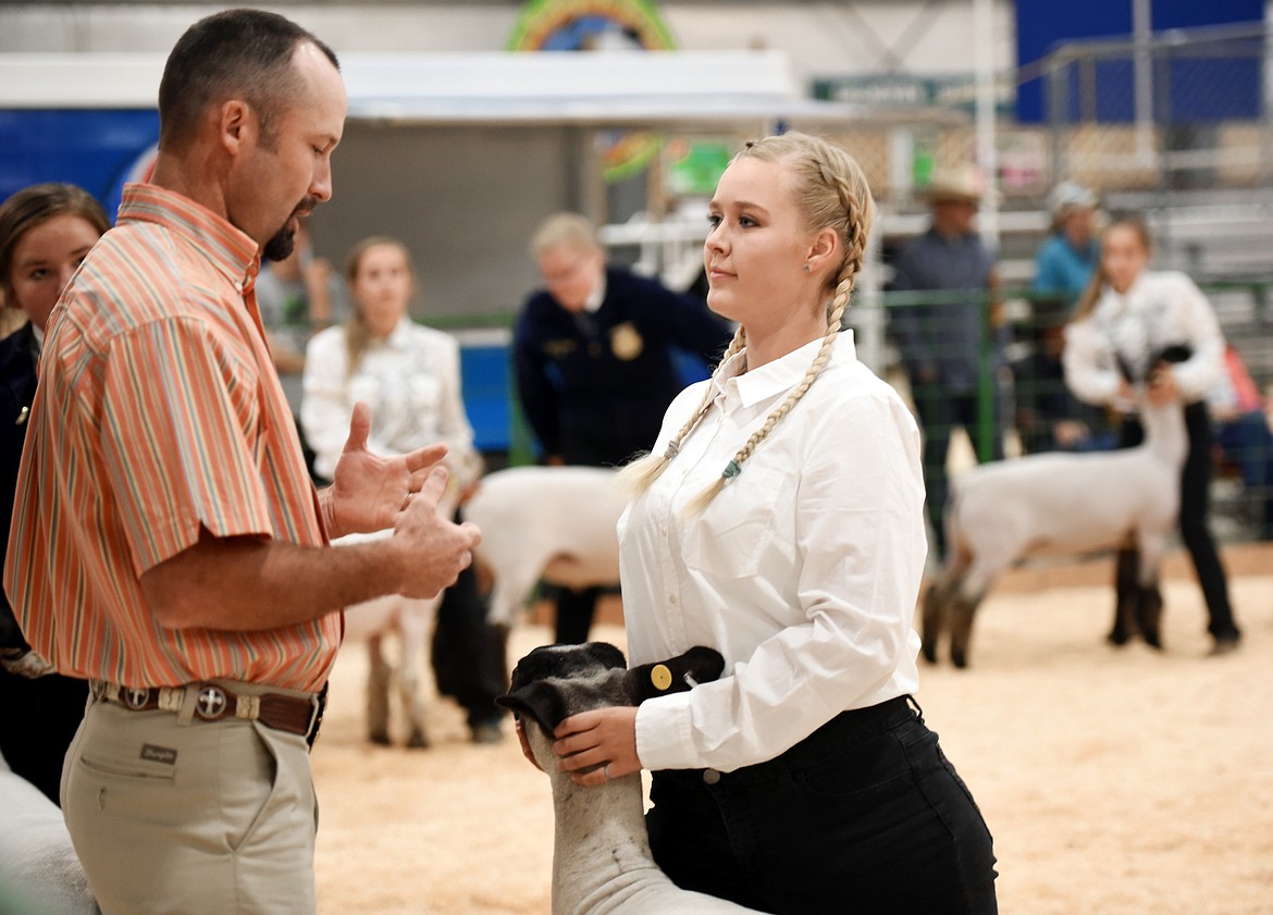 Judge Josh Stroh gives feedback to a competitor at the senior showmanship competition on Tuesday morning, August 14, at the Northwest Montana Fair at the Flathead County fairgrounds in Kalispell.(Brenda Ahearn/Daily Inter Lake)