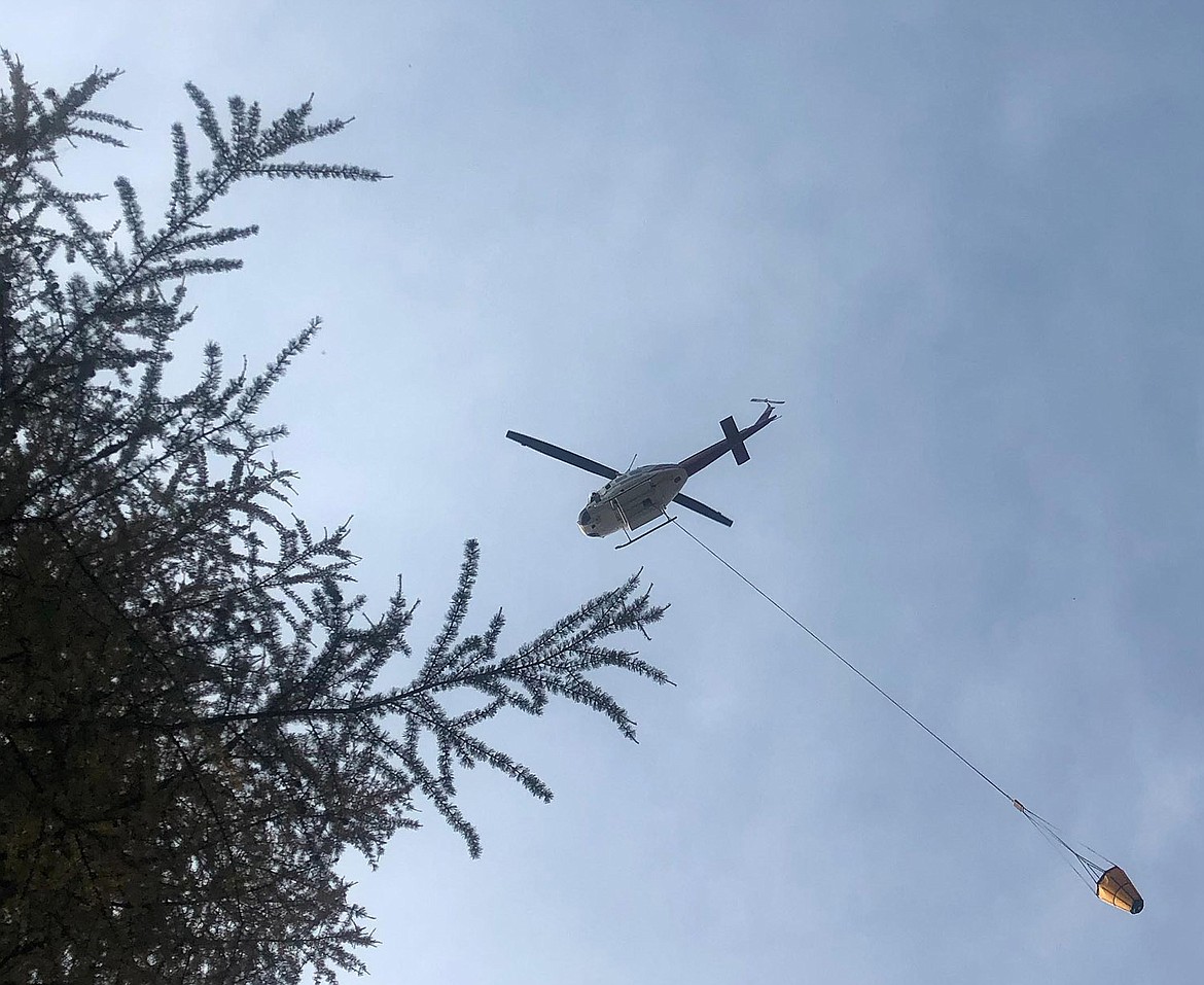 This photo of a helicopter preparing to drop water on the Davis fire was provided by the U.S. Forest Service/Kootenai National Forest.