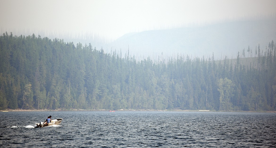 A boat taking off from Apgar heads across Lake McDonald on Monday morning, August 13. Three fires burning in the park have reduced visibility and air quality.(Brenda Ahearn/Daily Inter Lake)