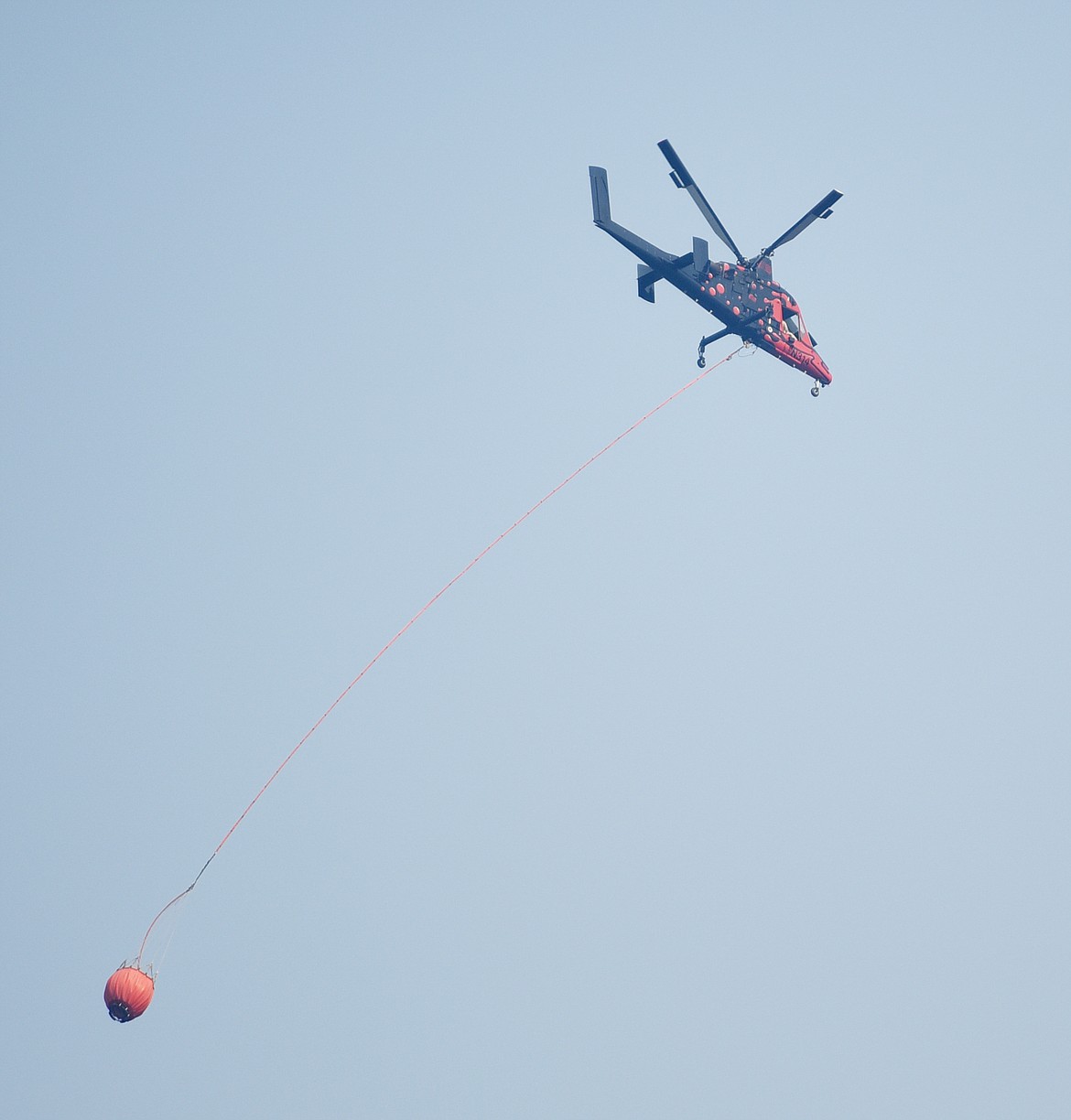 A helicopter flies toward the Howe Ridge fire on Monday, August 13, in Glacier National Park. There are currently three fires burning: Howe Ridge, Numa Ridge and the Heaven&#146;s Sake fire.
(Brenda Ahearn/Daily Inter Lake)