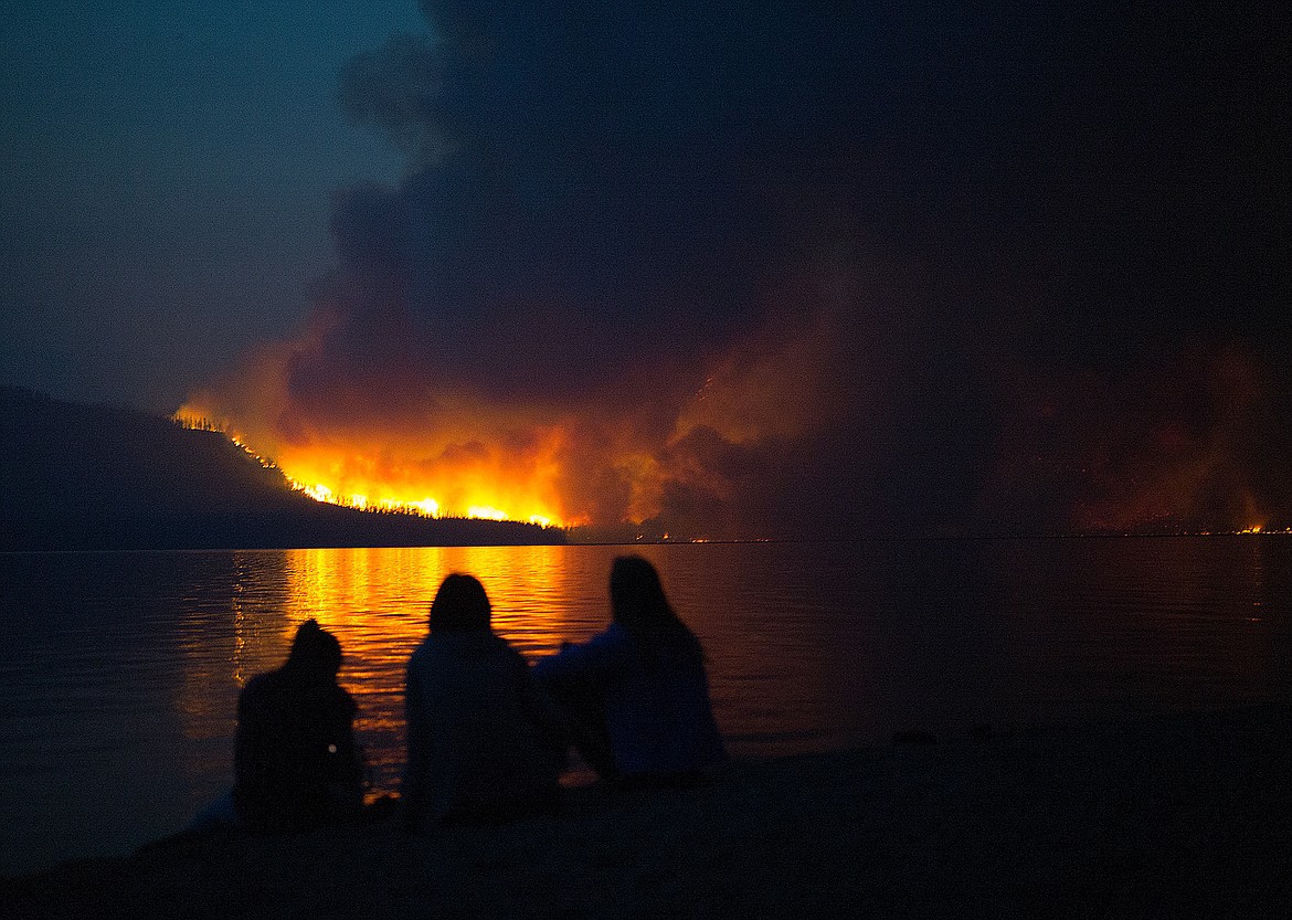 People watch the Howe Ridge Fire in Glacier Park Sunday evening.