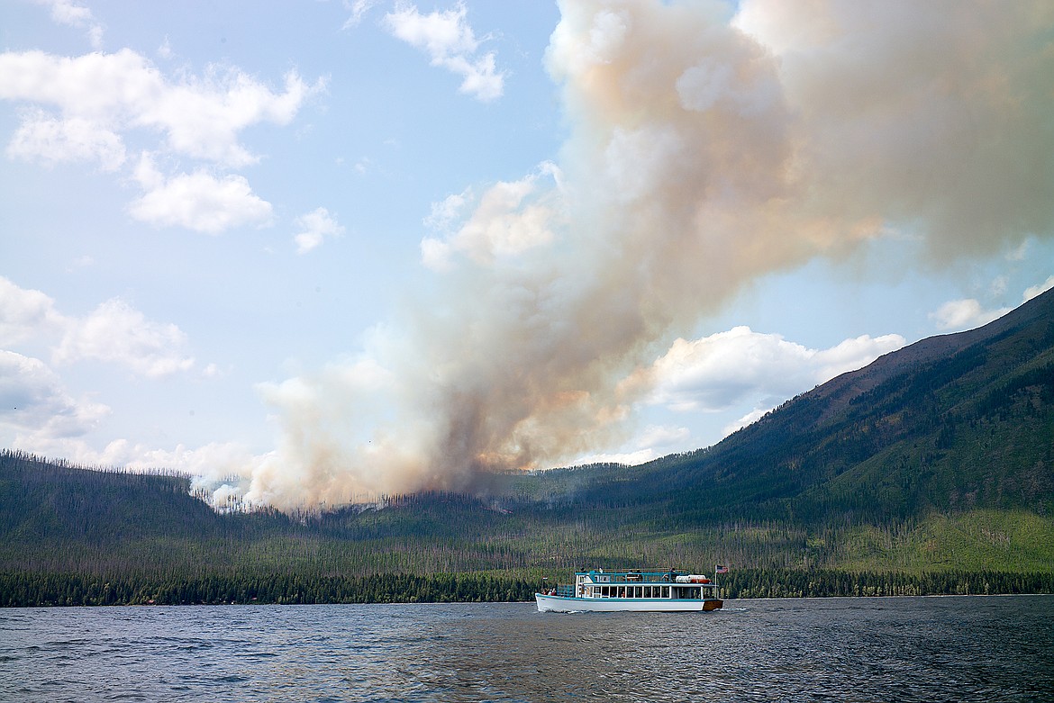 The DeSmet tour boat glides past the Howe Ridge Fire shortly after 3 p.m. Sunday.