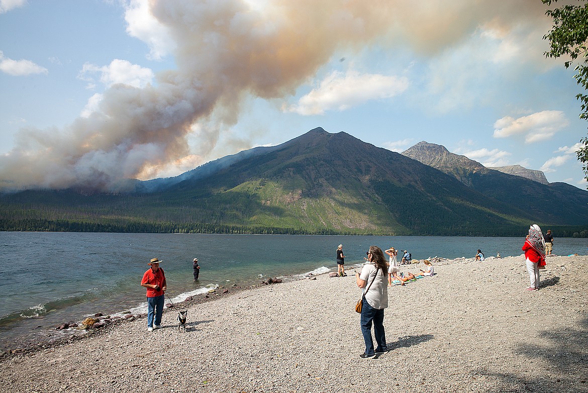 People watch the Howe Ridge Fire near Lake McDonald Lodge Sunday afternoon.