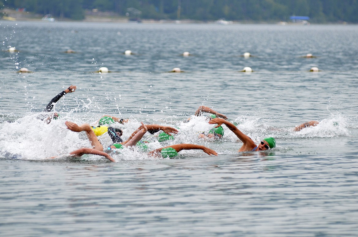 Swimmers begin the 1-mile race of the Whitefish Lake Swim off the shore of City Beach on Aug. 11. The swim is a fundraiser for the Wave fitness center. (Heidi Desch/Whitefish Pilot)