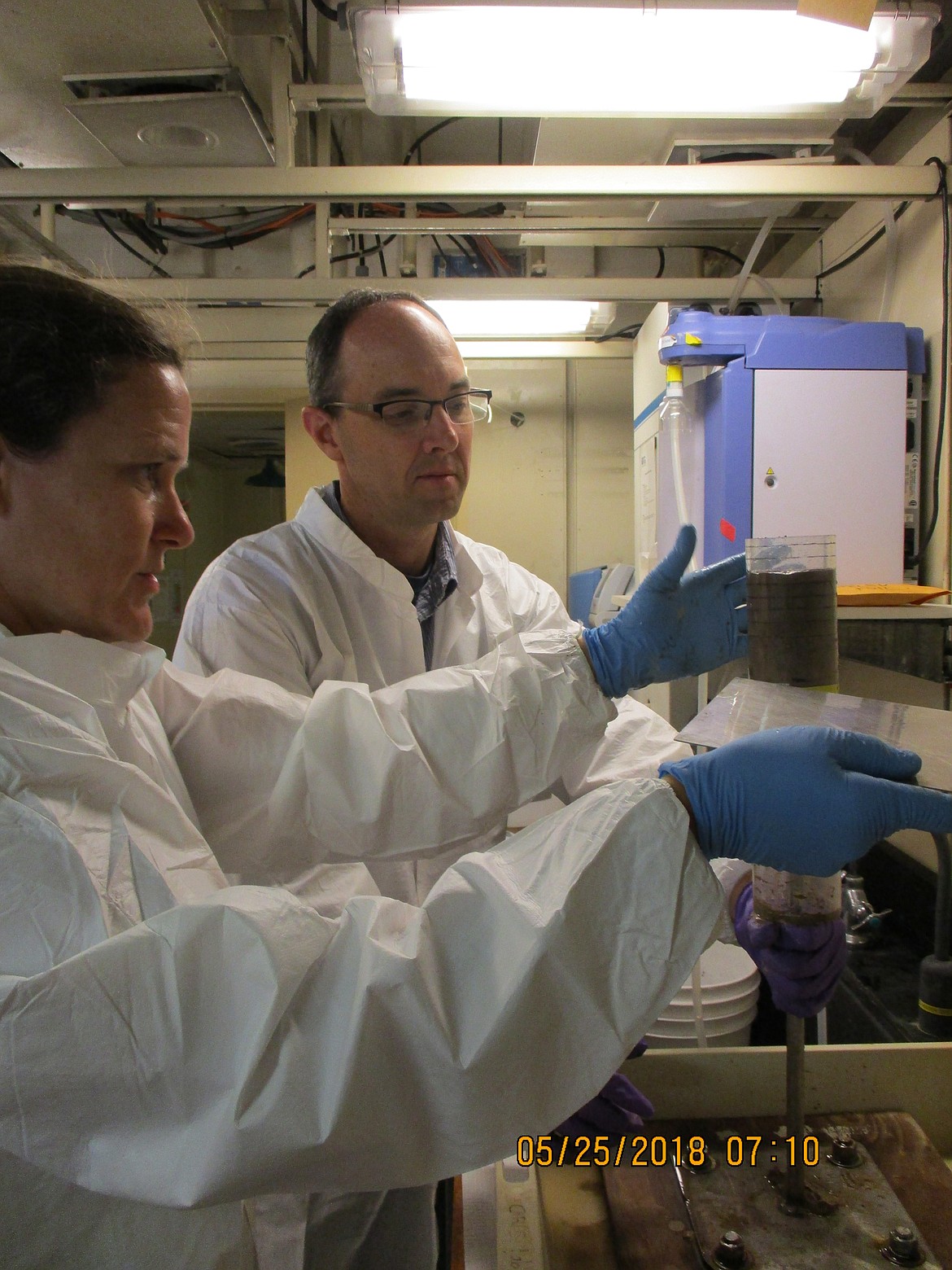 Matt Church (right) from the Flathead Lake Biological Station assists Erica Goetze (left) slice a sediment core sample taken from the research site for DNA aboard the SCOPE Cruise. //provided photo