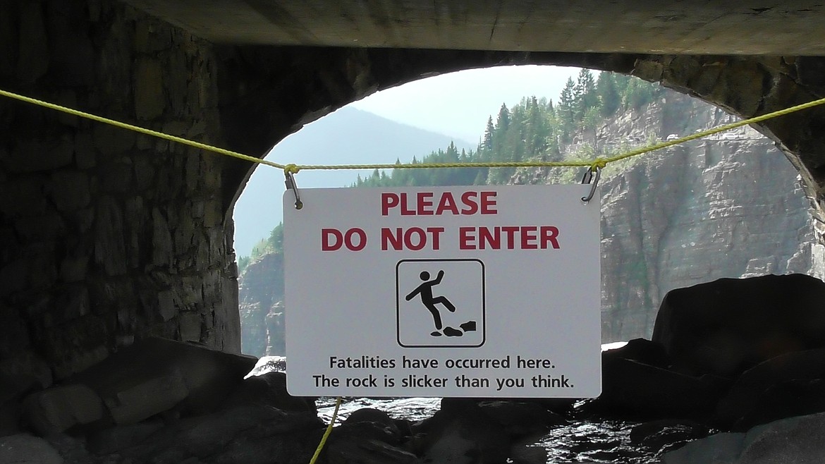 A warning signs hangs at the entrance to the Haystack Creek culvert under Going-to-the-Sun Road in Glacier National Park on Aug. 10. (Scott Shindledecker/Daily Inter Lake)