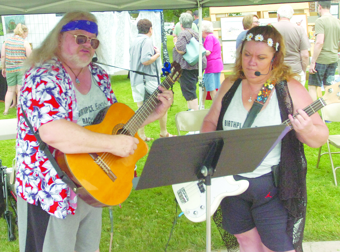 Mark and Kristi Reichman, know as The Wildflowers, entertain people attending the Sandpiper Art Festival last Saturday in Polson.