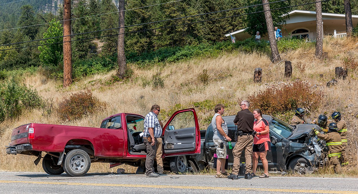 Lincoln County Sheriff’s Office and Libby Volunteer Fire Department work a two-vehicle collision that happened near mile marker 4 on Highway 37 12:30 p.m. Tuesday. According to Montana Highway Patrol Sgt. Neil Duram, Russell James, 48, of Spokane Valley, Washington was driving north in a Toyota Tundra when he collided with a Toyota T100 driven by a 16-year-old Libby boy attempting a u-turn. The boy was severely injured, taken to Kalispell Regional Hospital and has since been released. He faces pending charges for a right-of-way violation, failure to wear a seatbelt, and issues with his driver’s license. (John Blodgett/The Western News)