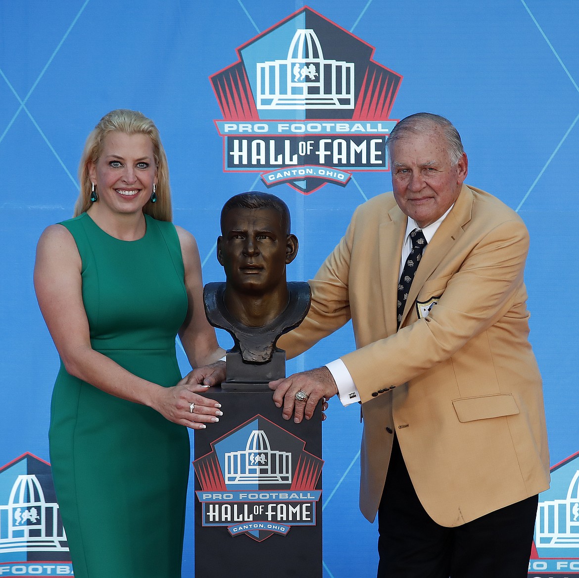 Former NFL player Jerry Kramer, right, poses with a bust of himself and presenter, daughter Alicia Kramer, during an induction ceremony at the Pro Football Hall of Fame, Saturday, Aug. 4, 2018 in Canton, Ohio. (AP Photo/Gene J. Puskar)