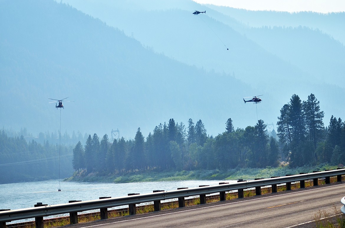 Three of the four helicopters that were apart of the attack on Friday afternoon and evening dipped into the Clark Fork River, which was in close proximity to the fire. (Erin Jusseaume/Clark Fork Valley Press)