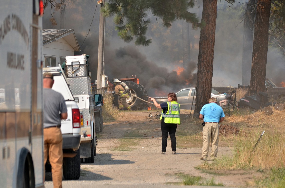 EMT personnel were on standby at the residence along Highway 200 where the fire began. (Erin Jusseaume/Clark Fork Valley Press)