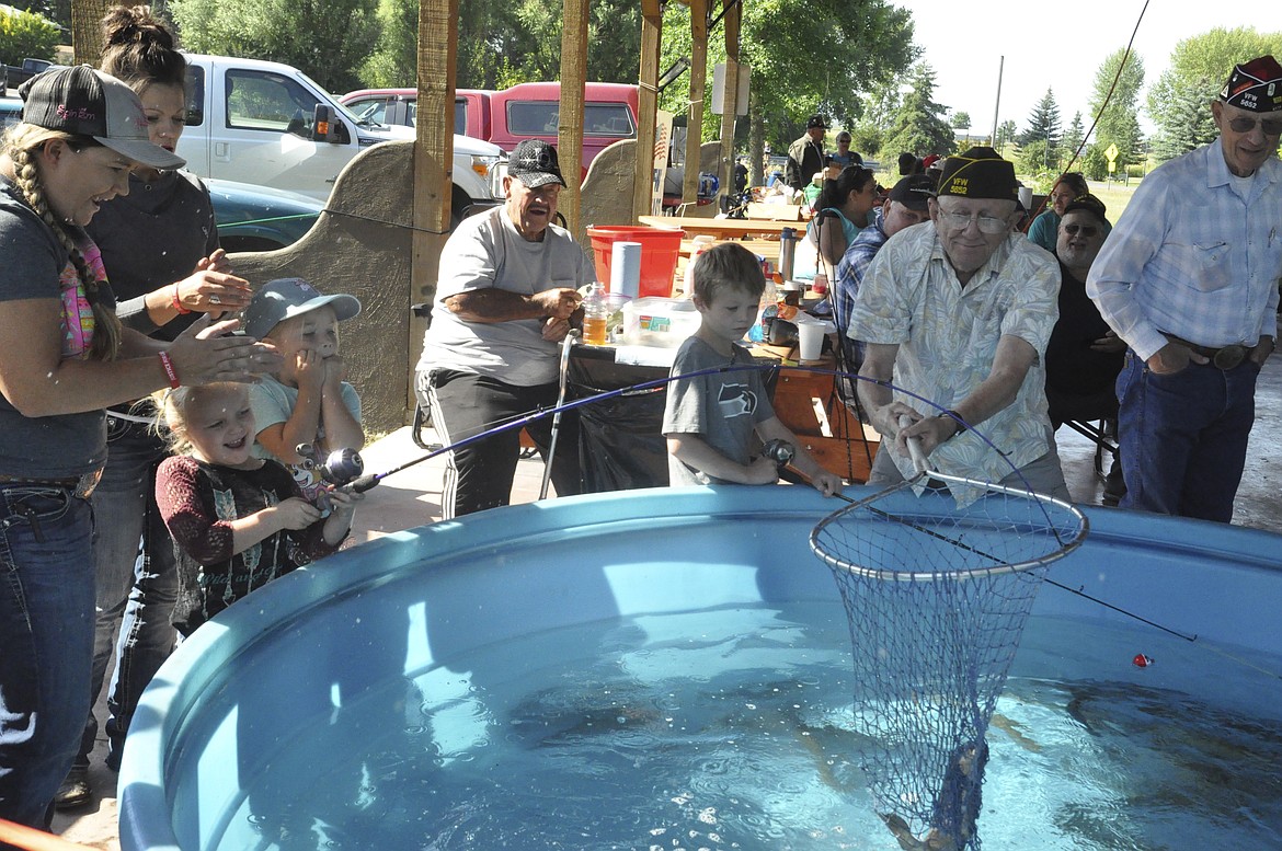 RILEY HARRIS, 5, reels in a rainbow trout during the Ronan Pioneer Days fishing derby, sponsored by the Ronan VFW. (Ashley Fox/Lake County)