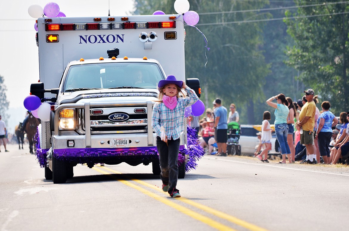 A cowgirl rides her stick horse as part of the Noxon Ambulance float during the parade.