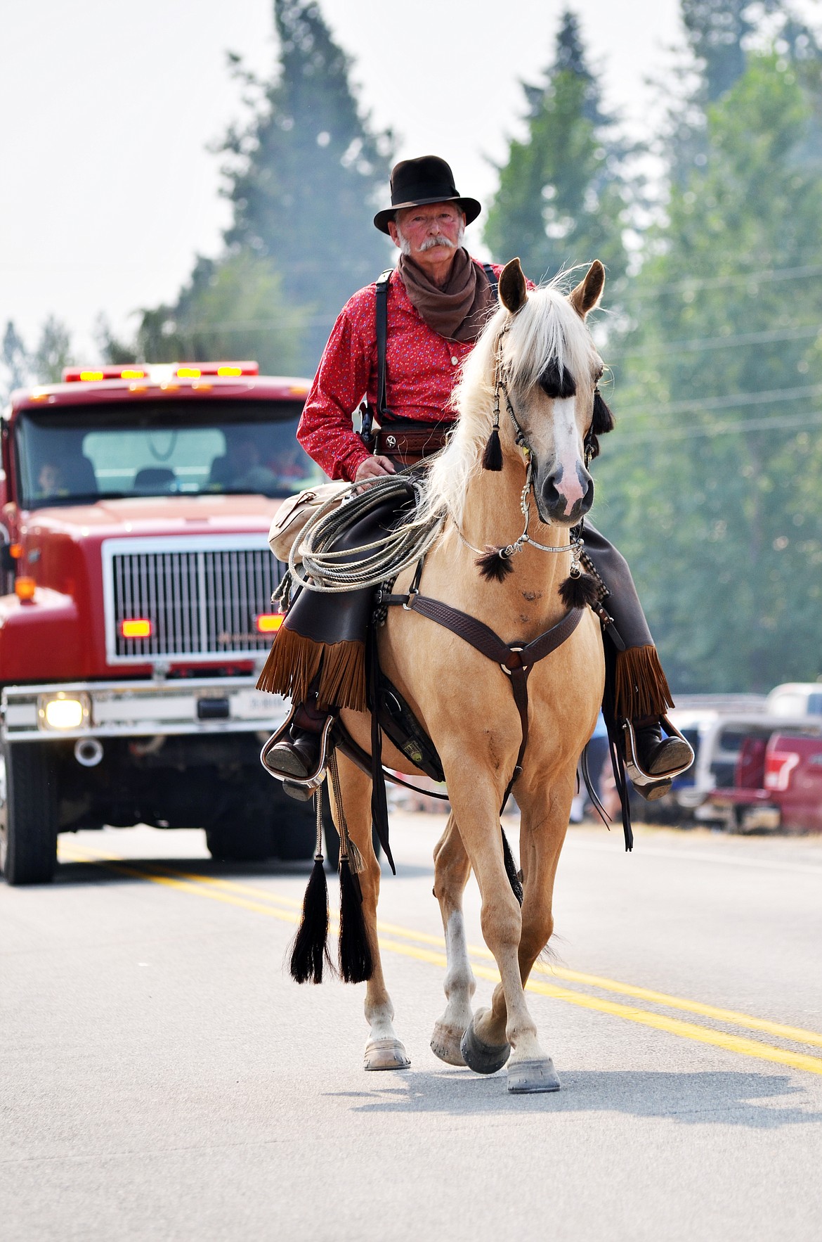 This cowboy is brought a little old west flavor as he nd his palamino walked down the parade (Erin Jusseaume/ Clark Fork Valley Press)