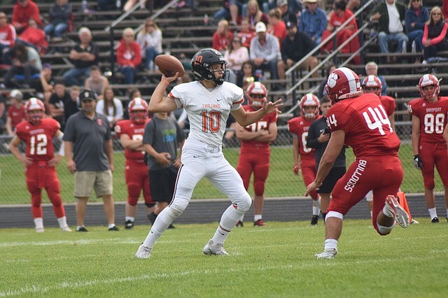 Photo by ANA PEARSE
Post Falls High junior quarterback Derek Pearse throws as Payton Cox (44) of Sandpoint rushes during Saturday&#146;s game at Post Falls. Post Falls won 34-7.