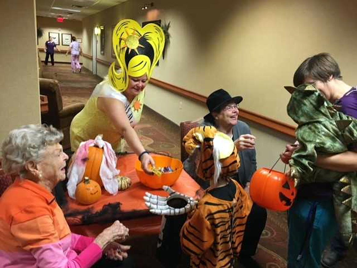 Courtesy photo
Garden Plaza activity director Wendy Lebsack passes out candy with residents to&#160;kids on the senior community&#146;s annual Halloween Safe Place Trick or Treating event.