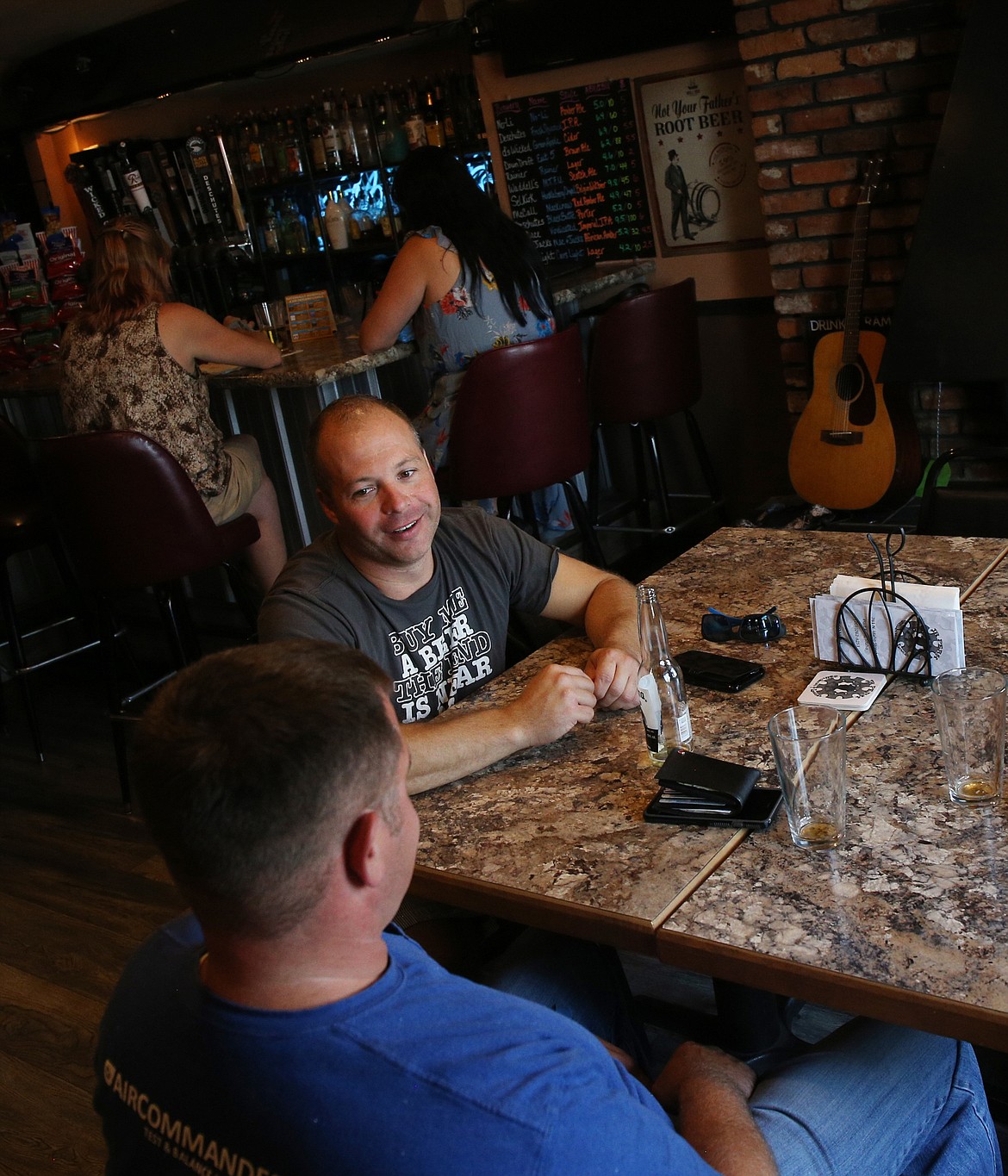 Customer Nathan Rogers catches up with a friend at JR Perk Coffeehouse and Lounge in Post Falls.