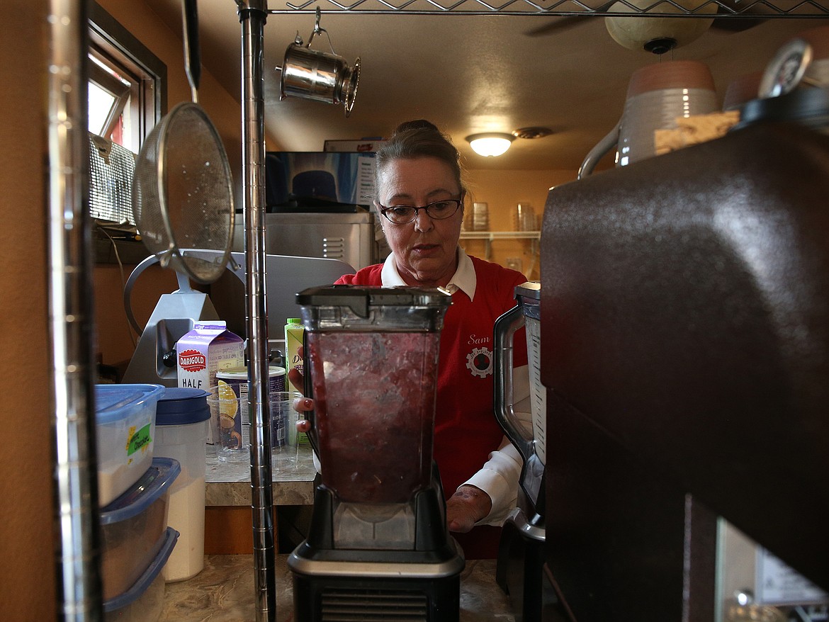 Owner Sam Johnson makes a smoothie for a customer at JR Perk in Post Falls. Aside from smoothies and coffee,  JR Perk also offers daily drink specials, growler fills and kegs to order.