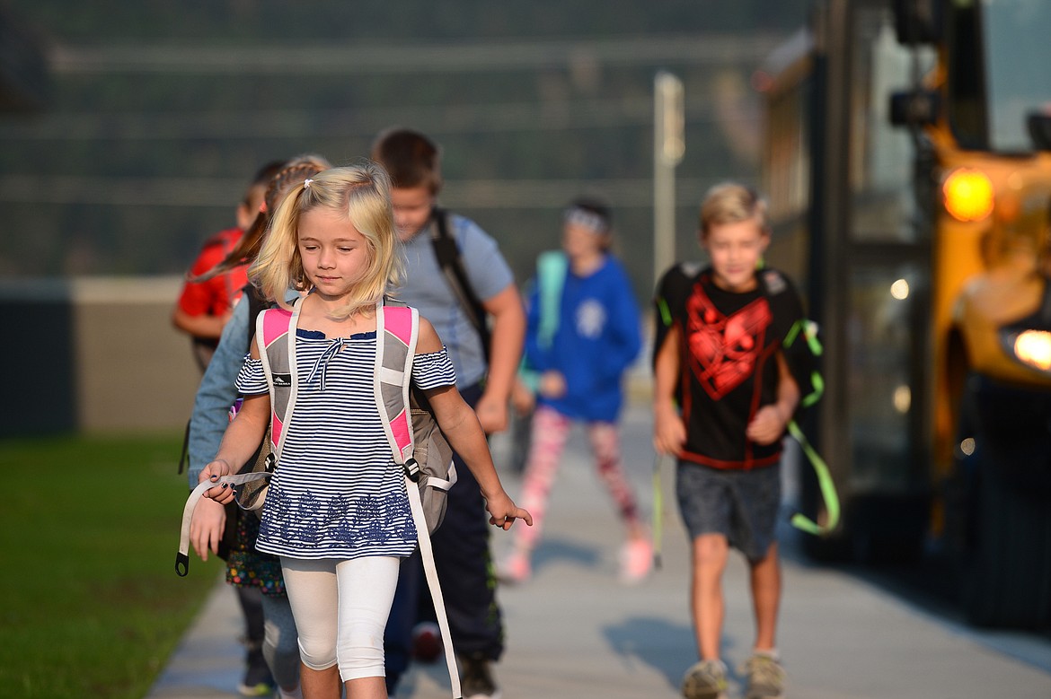 Children get off the school bus before the first day of school at Rankin Elementary School in Kalispell on Wednesday. (Casey Kreider/Daily Inter Lake)