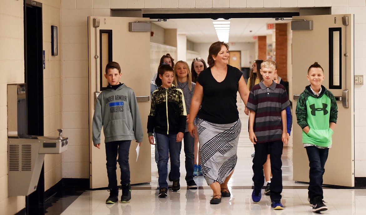 Anna Krueger leads a group of newly minted sixth graders through the halls of Kalispell Middle School on Wednesday, August 29 for Sixth Grade Day. For a number of years the school worked to create this day which is an opportunity for sixth graders to come to school, tour the building, figure out their lockers and a million other little details that can be overwhelming when the school is full and only two thirds of the students know where they are supposed to be going. &#147;It&#146;s a big adjustment coming here from the elementary schools,&#148; said Principal Tryg Johnson. &#147;We instituted this last year and found that we had a lot less tears and a lot less anxiety in our students. And I believe a great start leads to a great year.&#148;
(Brenda Ahearn/Daily Inter Lake)