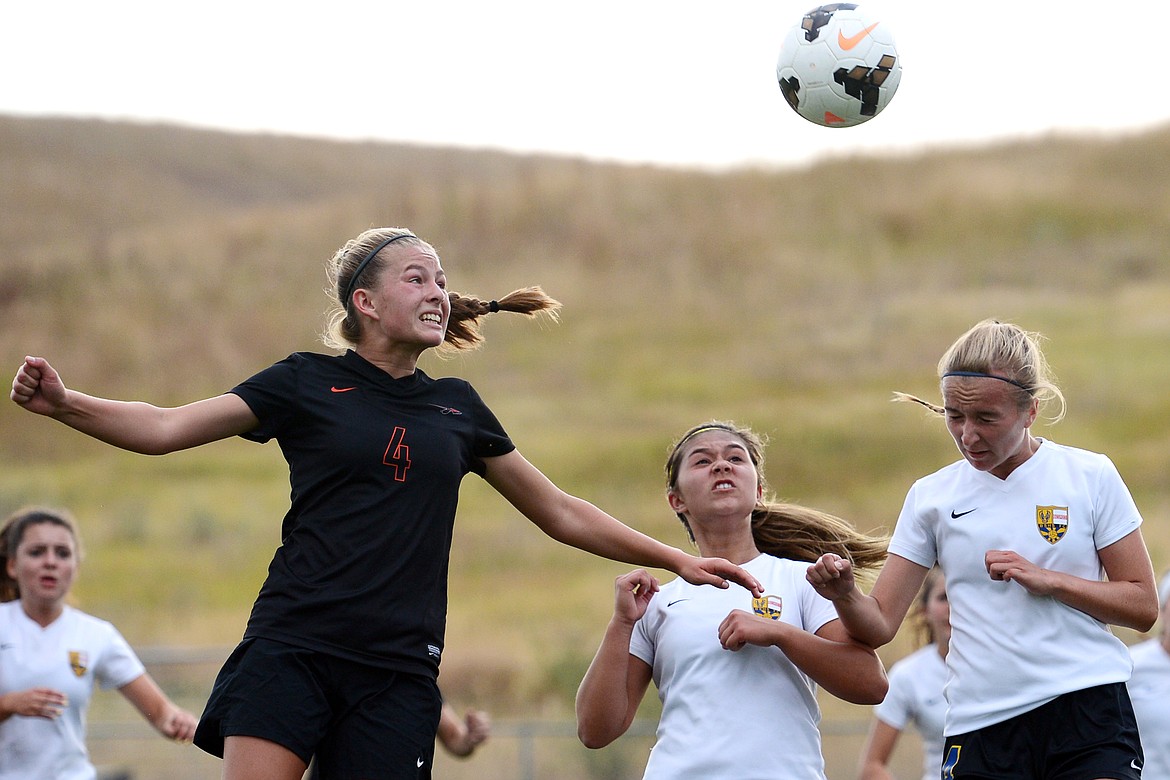 Flathead's Kami Darrow (4) battles for a header off a corner kick against Missoula Big Sky at Kidsports Complex on Tuesday. (Casey Kreider/Daily Inter Lake)