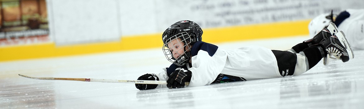 Grady Smith does a drill that requires him to get down on the ice and get back up on his skates.