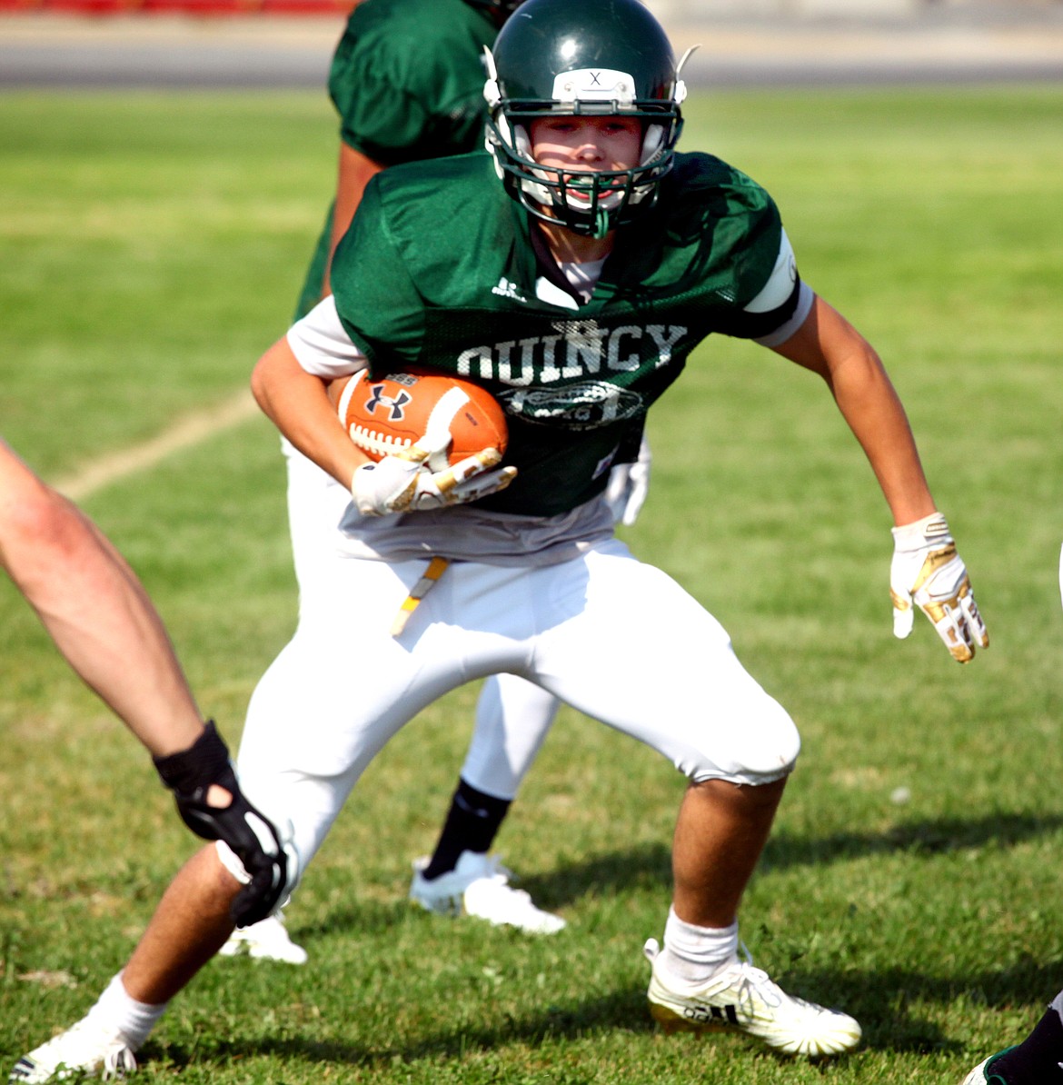 Rodney Harwood/Columbia Basin Herald
Quincy football will forfeit its 2018 season opener with Zillah on Friday night. Jacks head coach Wade Petersen cited safety concerns because his team has been confined to practicing indoors because of poor air conditions caused by wildfire smoke. The Jacks were finally able to practice for the first time on Monday. Here Connor Donovan runs through the gap during a drill on Tuesday.