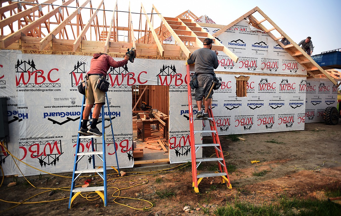 From left, Joshua Haynes, Jason Beckstead, and Ryan Hargrave working on an Iron Star Construction site on Ali Loop in north Kalispell on Thursday morning, August 23.(Brenda Ahearn/Daily Inter Lake)