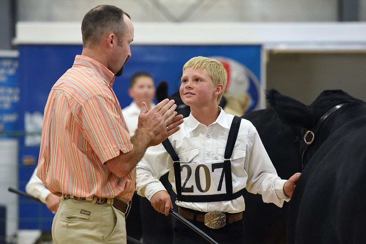 Sam Plummer, right, speaks with livestock judge Josh Stroh during the beef showmanship and market judging at the Northwest Montana Fair on Tuesday, Aug. 14. (Casey Kreider/Daily Inter Lake)