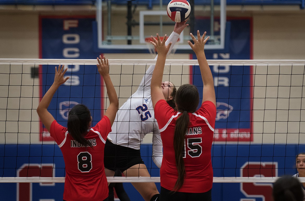 Wildkat Kiera Brown goes up for a kill against Browning&#146;s Candace Still Smoking and Abby Bullcalf Monday. (Jeremy Weber photo)